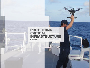 man in military uniform holding a drone over his head on a boat
